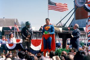 CW-SIII-Ricky-Lana-Gus-Superman-Mayor-on-stage-holding-Kryptonite-slide